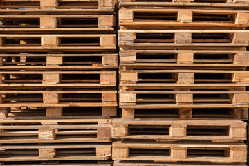Stacked Wooden pallets in storage. Wooden pallets, showcasing their structure and texture. This image highlights the practicality of pallets in storage and logistics.
