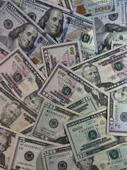 Scattered US dollar bills on a white background. Chaotic money spread representing finance, wealth, risk, cash flow or economic concepts