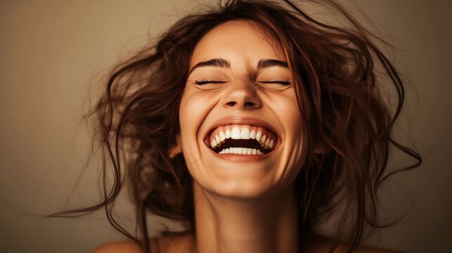 Woman laughing heartily enjoying a moment of pure joy and happiness