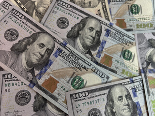Scattered US dollar bills on a white background. Chaotic money spread representing finance, wealth, risk, cash flow or economic concepts