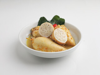 Squid with tofu filling cooked in curry sauce in white bowl