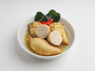 Squid with tofu filling cooked in curry sauce in white bowl