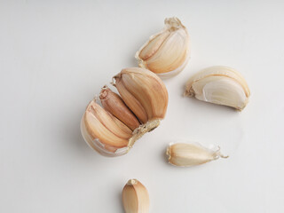Garlic cloves on white background