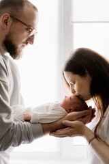 Fototapeta premium Candid portrait of cute little child with parents