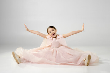 Joyful Girl in Pink Dress with Outstretched Arms