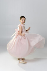 Joyful Girl Twirling in Pink Dress