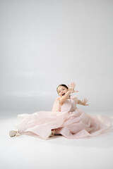 Playful Girl in Pink Dress Posing
