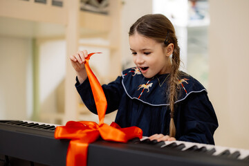 Excited Girl Unwrapping Gift-Wrapped Keyboard
