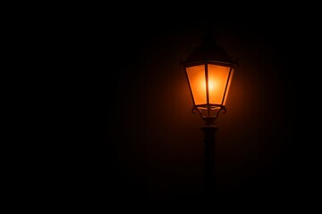 Vintage street lamp glowing in the dark