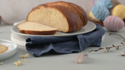 Traditional Portuguese Easter folar, sliced on a plate with colorful eggs