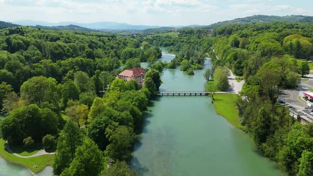 Otočec, Slovenia, a castle on the river, aerial footage, drone video a green river and castle on the island