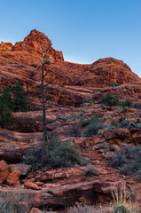 Red rocks in Sedona visible as hill is in shade during sunset golden hour in Arizona