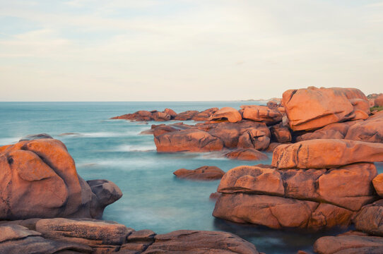 France,Bretagne.Pink granite rock formations at the coast  on a sunny summer evening