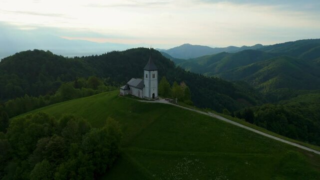 Amazing light rays above the church on the hill in Jamnik, Slovenia, saint Primus and Felician, drone video, aerial footage