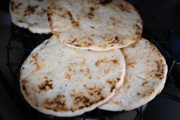 Arepas. Close-up on a Colombian woman serving arepas for a traditional breakfast. Arepas food