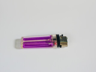 A close-up of a purple gas lighter, isolated on a white background.