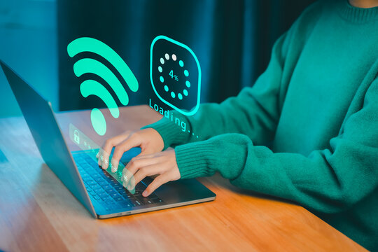 Person typing on a laptop with glowing Wi-Fi and loading graphics, symbolizing internet connectivity, online access, download digital business data form website, and slow data transfer progress.