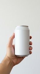 Close Up Hand Holding White Aluminum Soda Can in Bright Studio