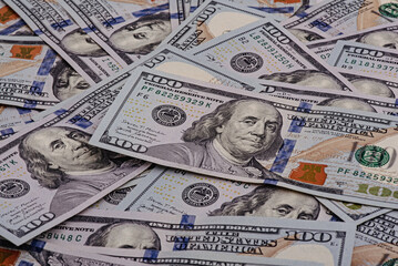 American dollars in denominations of one hundred as a background.