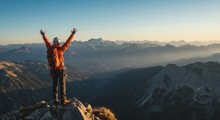Man On Mountain Peak With Orange Jacket Enjoying Freedom And View