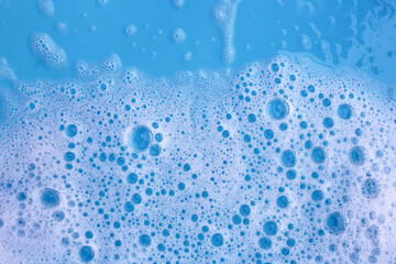 Blue water with white foam bubbles