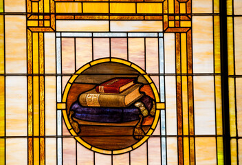 Detail of a stained glass window in a church showing a depiction of the Holy Bible_20101003_03688.