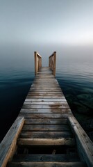 Fototapeta premium Serene Dock Extending to the Horizon: A weathered wooden dock extends gracefully towards the distant horizon, disappearing into a tranquil, misty atmosphere over calm water.