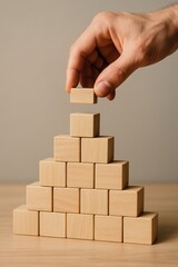 Hand Prevents Wooden Block Collapse Risk Management