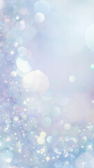 Sparkling glitter in soft, light blue colors. Dreamy shimmering particles glowing softly in a blurry bokeh of white and blue lights. Dreamlike blurred abstract background of soft pastel colors.