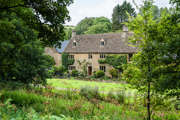 Fototapeta premium House in Upper Slaughter, Lower Slaughter, Cotswold district of Gloucestershire, England, UK