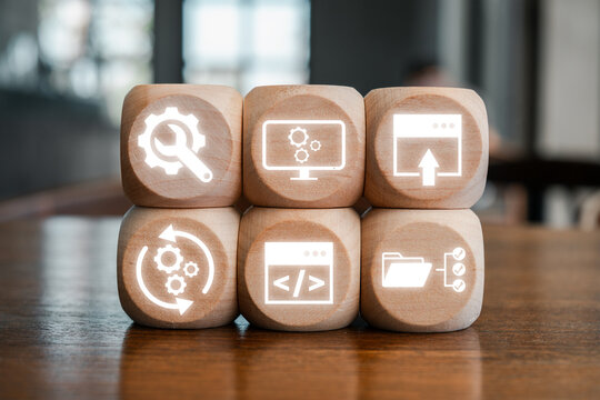 Wooden blocks with digital icons representing software development kit concepts, ideal for tech and programming themes.