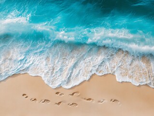 Ocean waves crashing on sandy beach footprints
