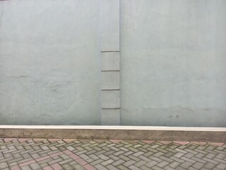 Minimalist Concrete Wall with Paving Block Ground Texture