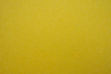 Full frame shot of recycled yellow paper sheet texture and background. Colored paper or construction paper, is a type of paper that comes in a wide range of colors.