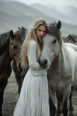 Obraz premium a woman with a beautiful face in a flowing white dress. She stands and gracefully hugs the horse in the open steppe