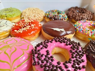 donuts are topped with different glazes, sprinkles, and patterns