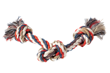 A colorful braided rope dog toy with knotted ends against a plain black studio background shot close up