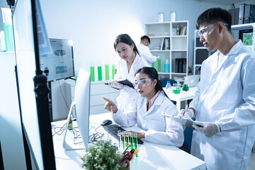 In the laboratory, a biologist uses advanced technology and computer analysis to compare data from...
