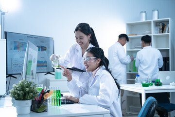 In the laboratory, a biologist uses advanced technology and computer analysis to compare data from experiments, conducting research to uncover new scientific insights in biology.