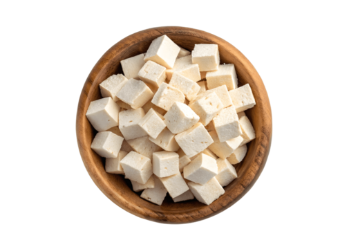 Diced tofu in a wooden bowl isolated on transparent background, top view, healthy food