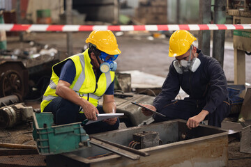 teamwork : Officials from the Department of Hazardous substances control bureau is investigating the leak of a hazardous chemical in chemical industry plant. Man with safety protective mask in factory