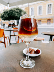 Enjoying cold coffee with lime and ice cubes at a cozy outdoor cafe in the afternoon