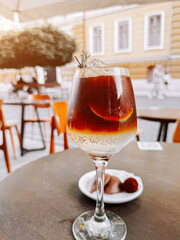 Cold coffee with lime and ice cubes enjoyed on a sunny day at a cafe terrace