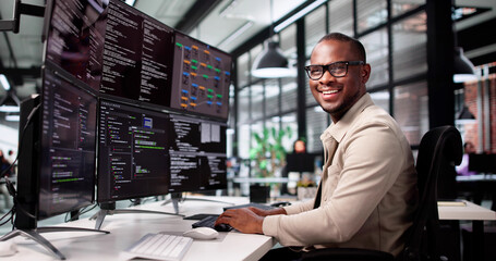 Smiling African-American Man Developing Web Code