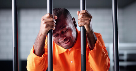 Sad African American Man Behind Bars