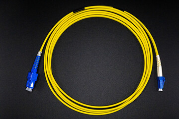 Yellow Fiber Optic Cable with Blue LC Connectors Coiled