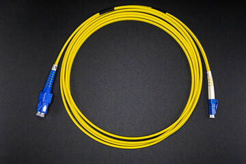 Yellow Fiber Optic Cable with Blue LC Connectors Coiled