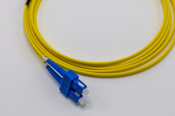 Close Up of Yellow Fiber Optic Cable with Blue Connectors