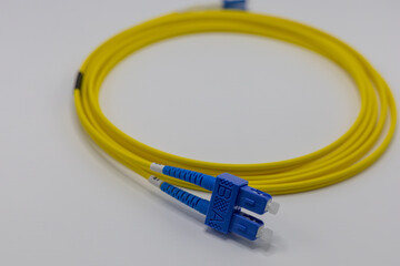 Close Up of Yellow Fiber Optic Cable with Blue Connectors