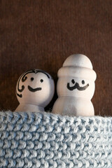 wooden peg dolls symbolizing man and woman under a duvet in bed